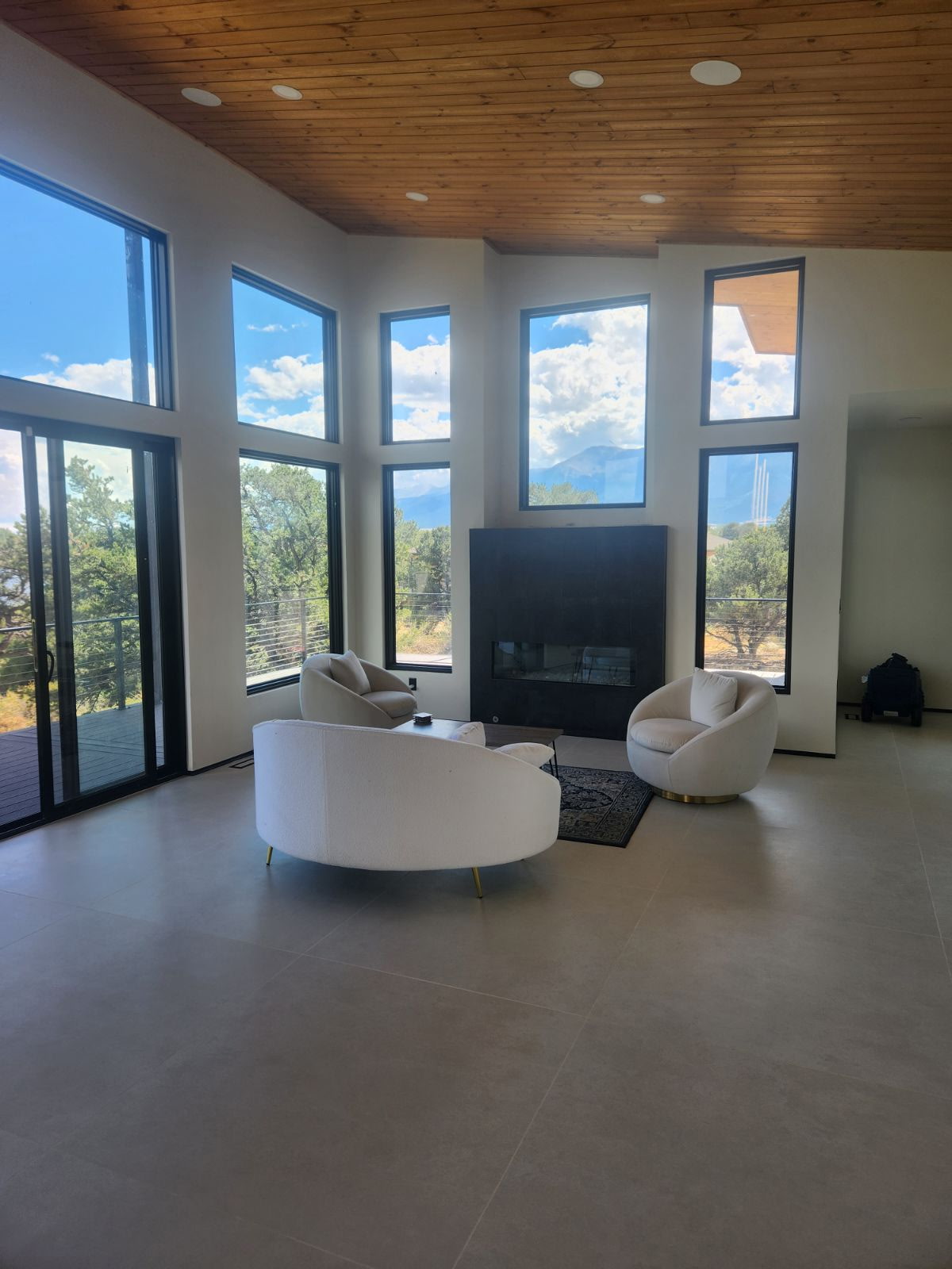Great room with floor-to-ceiling windows, wood ceiling and modern fireplace